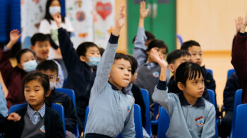 Children raising their hands to answer a quiz • Clean the World Asia • Green hygiene education events with Hong Kong charity