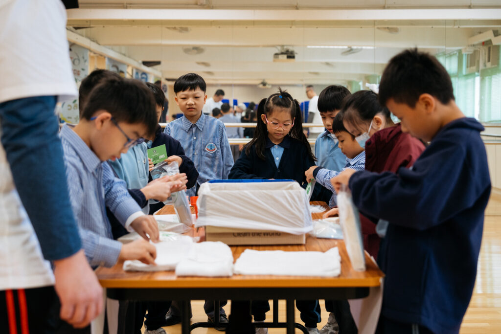 Group of school children packing hygiene kits • Clean the World Asia • Green hygiene education events with Hong Kong charity